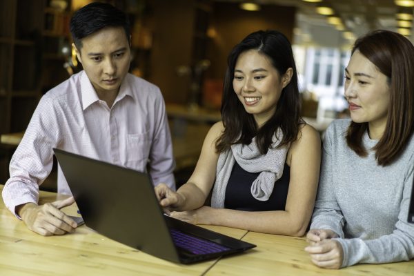Asian students discussing work